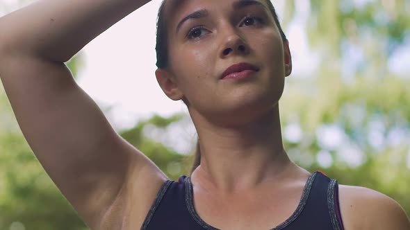 Woman Wipes Sweat After Exercising Outdoors in Park Slow Motion, Beautiful Lady