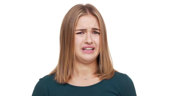 Close Up Studio Portrait of Displeased Female with Auburn Hair Feeling Aversion Demonstrating Her