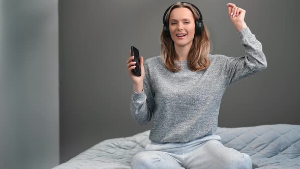 Funny Lady Relaxing Bedroom in Headphones Dancing Enjoying Audio Sound