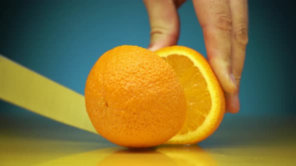 Cutting Process Horizontal Shot of Male Hands Cutting Orange Fruits