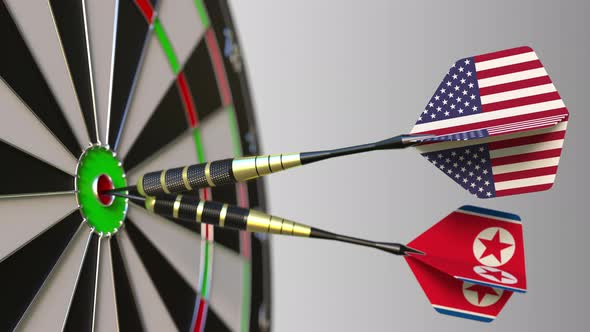 Flags of the USA and North Korea on Darts Hitting Bullseye alt