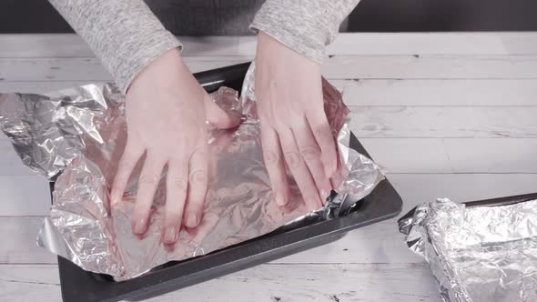 Step by step. Lining the baking pan with cooking foil to make homemade fudge.