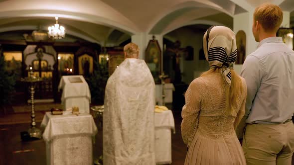 Blurry Process of Christening in an Orthodox Church From Behind