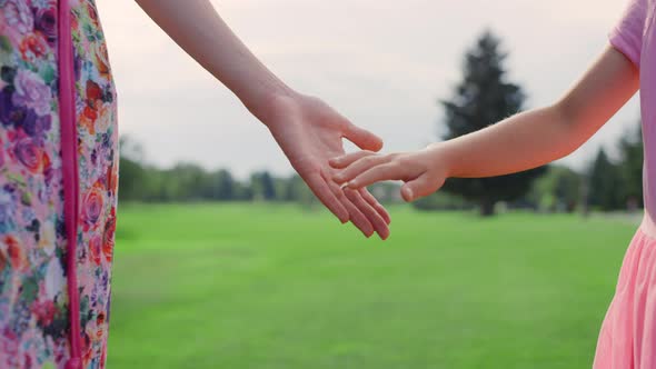 Unknown Woman Holding Girl Hand Outdoor