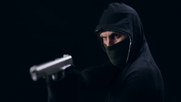 Masked Robber Aiming with Gun