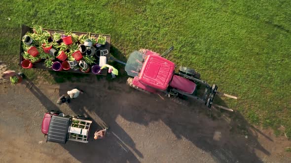 Aerial view of following tractor down country road in the rolling hills of West Virginia.