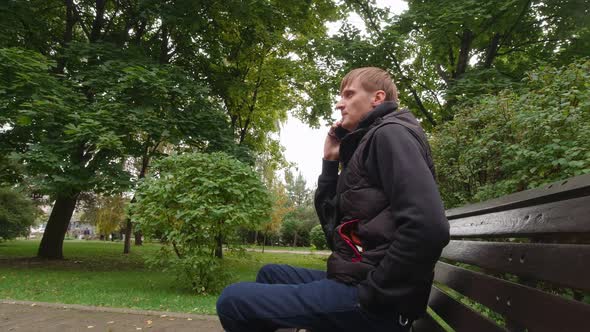 Man Talking On The Phone In The Park