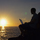 Sitting with a Laptop at Sunrise - VideoHive Item for Sale