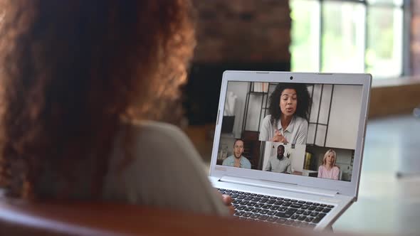 Curly Woman Looking at the Laptop Screen with People Profiles