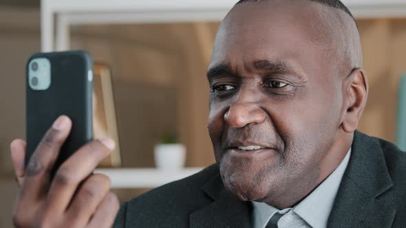 Closeup African American 50s Old Middleaged Businessman Emotional Talking with Smartphone Video Call