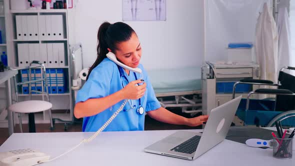 Physician Nurse Speaking at Phone with Patient Analysing Xray