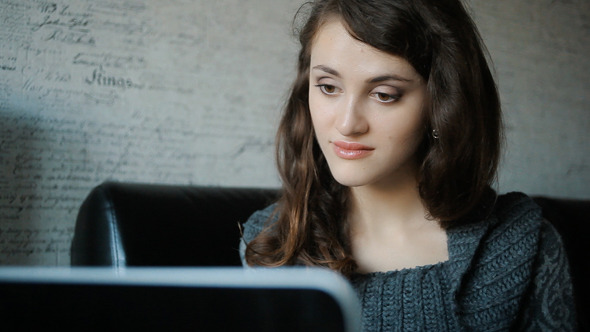 Attractive Woman Working At Home On A Laptop