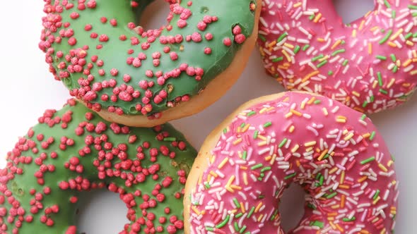 Top View Fresh Doughnuts Covered By Icing and Pastry Topping Closeup