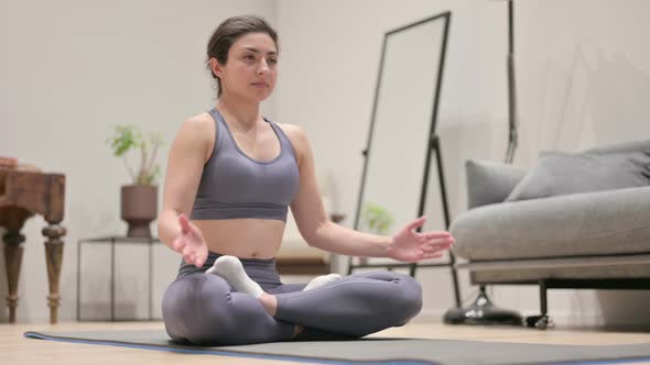 Young Indian Woman Meditating on Yoga Mat at Home