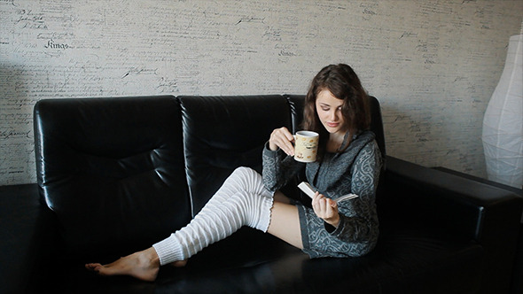 Young Woman Reading Book And Drinking Coffee 
