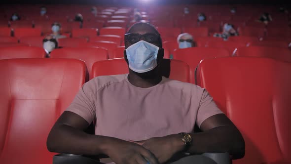 Portrait of Masked African American Man in Cinema