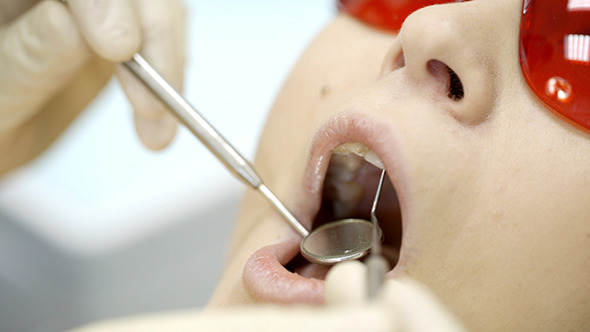Woman Being Under Dentists Examination