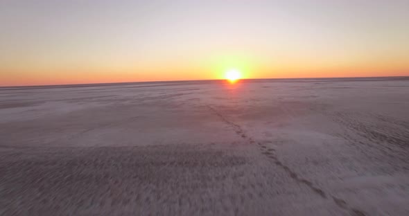 Aerial drone view of sunset over a desert in Africa plains.