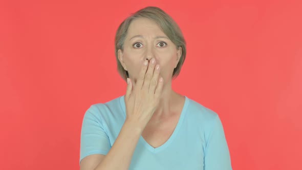 Shocked Old Woman on Red Background