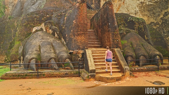 Tourist Climbing the Lion's Paw Staircase Entrance to the Sigiriya Fortress, Sri Lanka