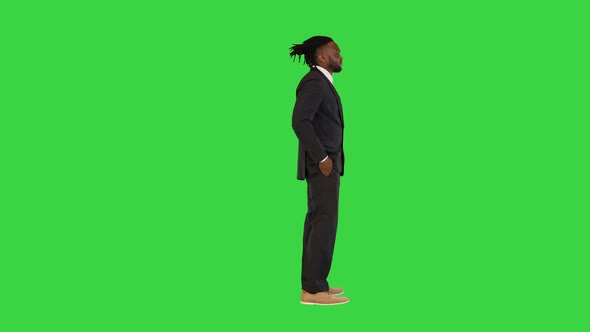 Black Man in Office Suit Having a Conversation on a Green Screen Chroma Key