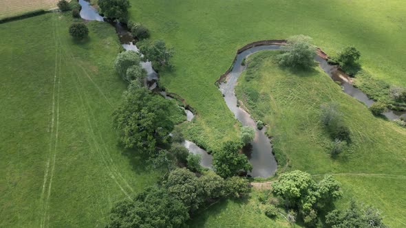 An aerial view of the tiny river Arrow as it twists it's way through the Warwickshire countryside, E