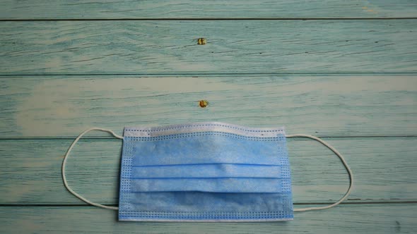 Protective Mask and Pills on Wooden Background Stop Motion Animation, Coronavirus Pandemic alt