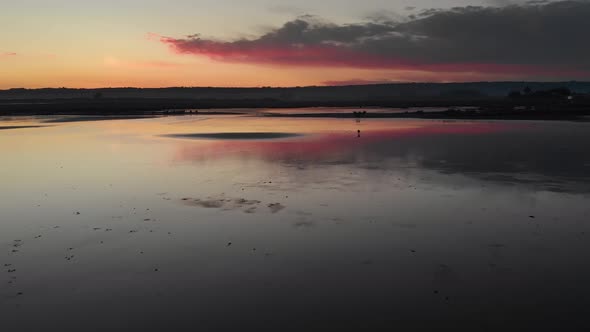 reflecting lake at sundown silhouette aerial couple together