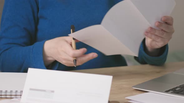 Female Hands Opening Envelope Letter Document or Bills Reading Writing Down