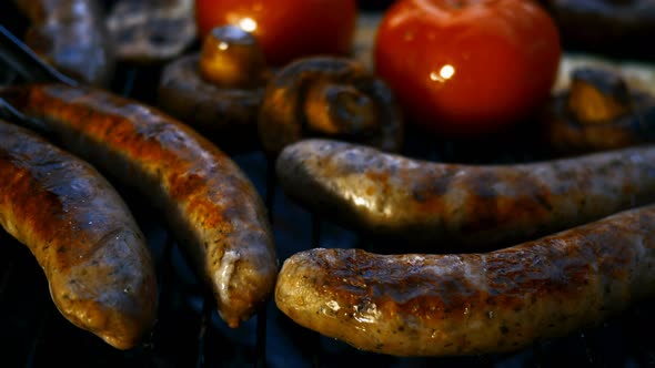 Frying Fatty Bavarian Sausages Cooked on Grill or Barbecue Grid