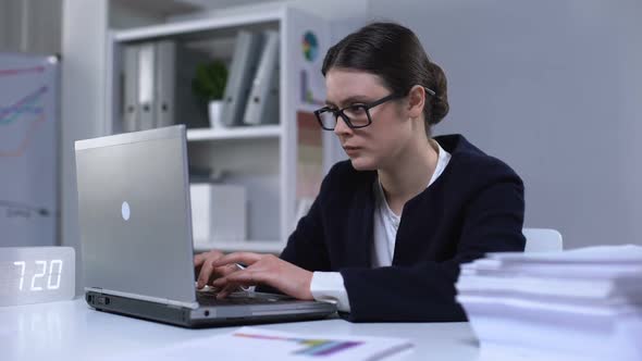 Businesswoman Typing on Laptop and Suffering Headache as Result of Workload