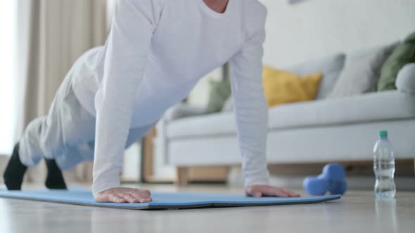 Close Up of Sporty Man Doing Pushups on Yoga Mat at Home