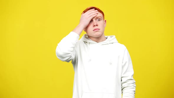 Tired Young Redhead Man Touching Head Having Migraine and Headache