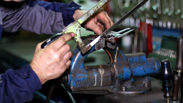 Sawing a Screw with a Hacksaw