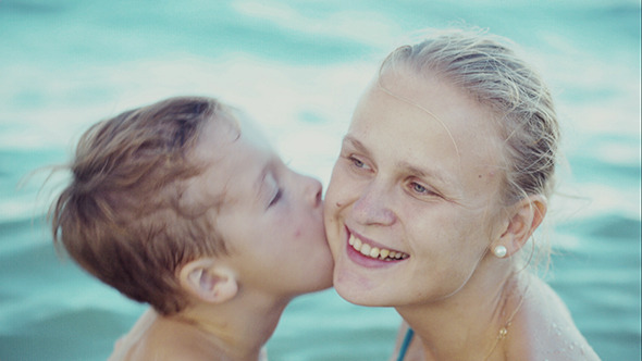 Boy Kissing Mother While Bathing In The Sea