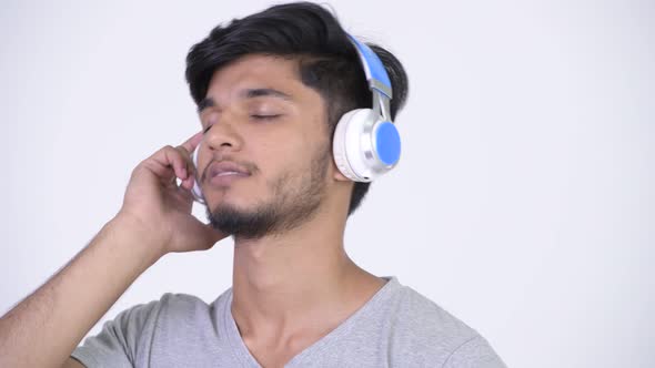 Young Happy Bearded Indian Man Listening To Music