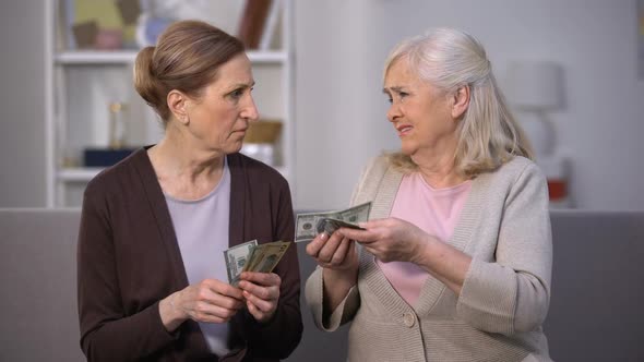 Senior Female Holding Dollars Complaining Friend on Poverty Problem, Low Income