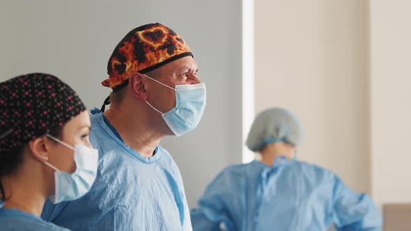 Caucasian Surgeon Male Healthcare Professional in a Hospital Operating Theater