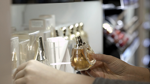 Woman Choosing Perfume With Paper Tester