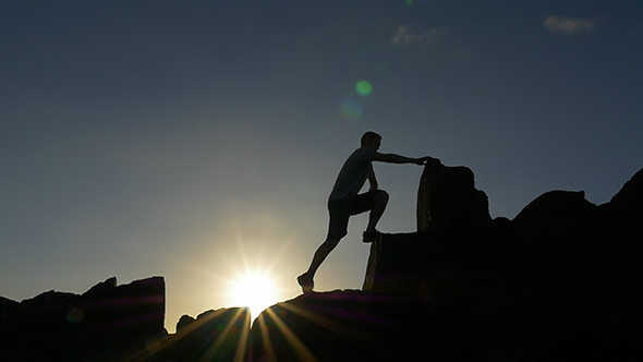 Climbing a Rocky Mountain at Sunrise