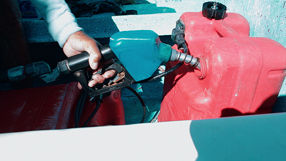Man Fueling Tank Of A Motor Boat Before Travel