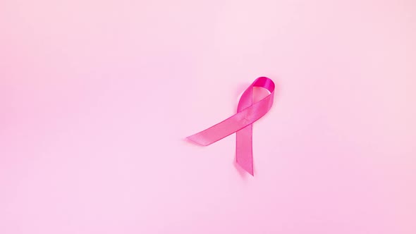 Pink Ribbon and Stethoscope on Colored Background