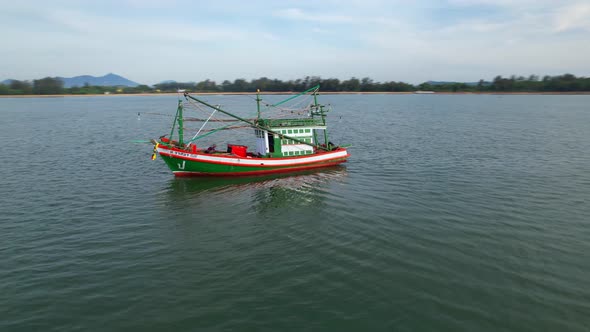 A fisherman is sailing in the sea among the islands near the coast.