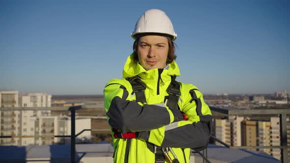 Climber in White Helmet Crosses Arms and Smiles to Camera