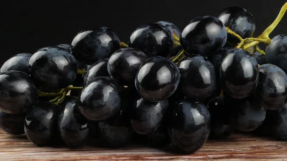 Dark blue grape on black background