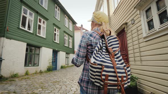 Tourist with a Map in Her Hands Walking Through the Narrow Streets of Bergen in Norway