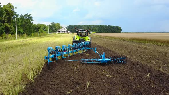 Tractor Working In The Agricultural Field. Agricultural equipment ready for ploughing the fields