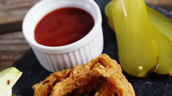 Snacks and ketchup on wooden table