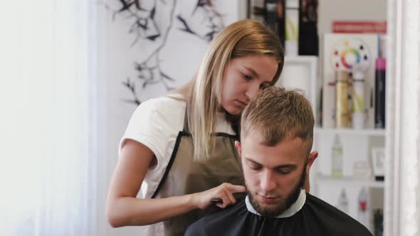 Stylist Doing Stylish Haircut for Client in Barber Shop