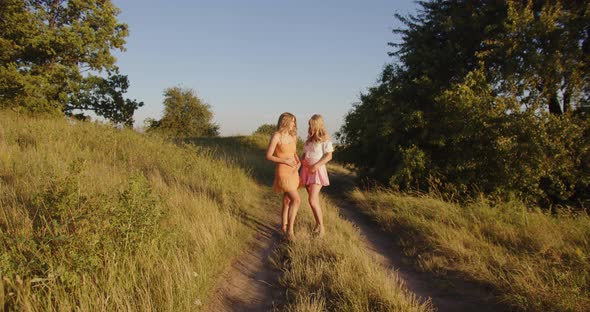 Two Pregnant Girls are Walking in Nature